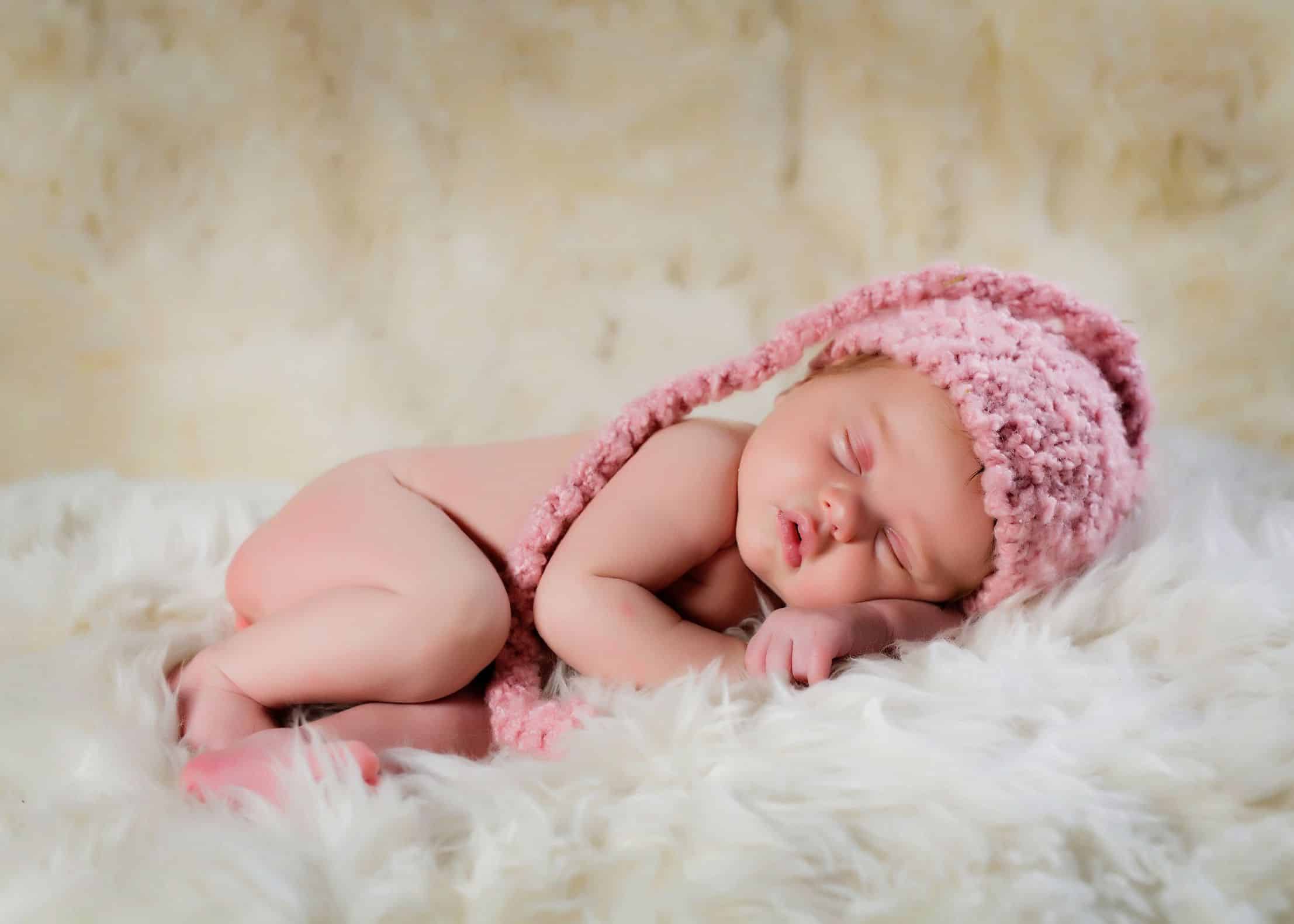 newborn wearing knit hat