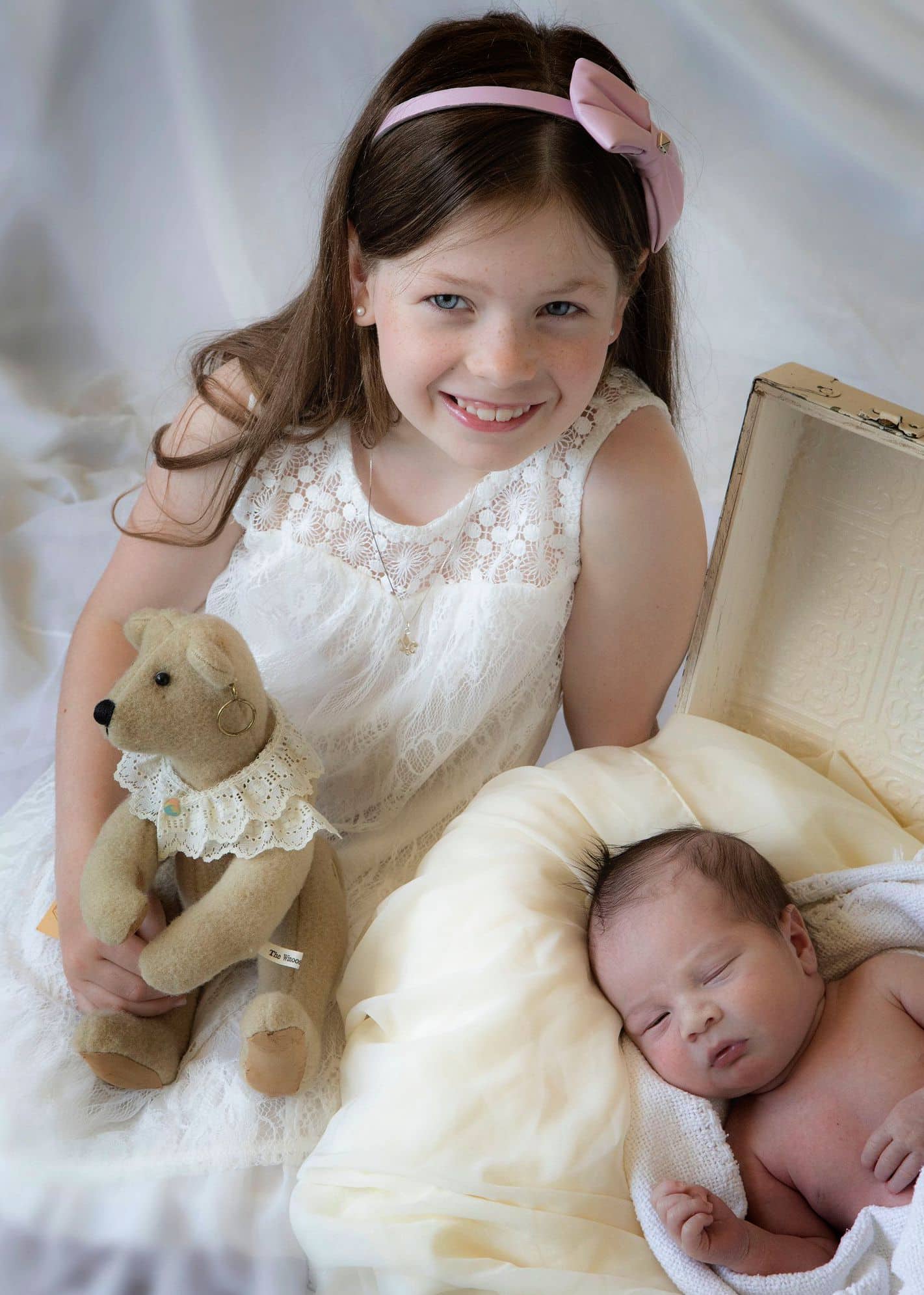 toddler and newborn posing for photo